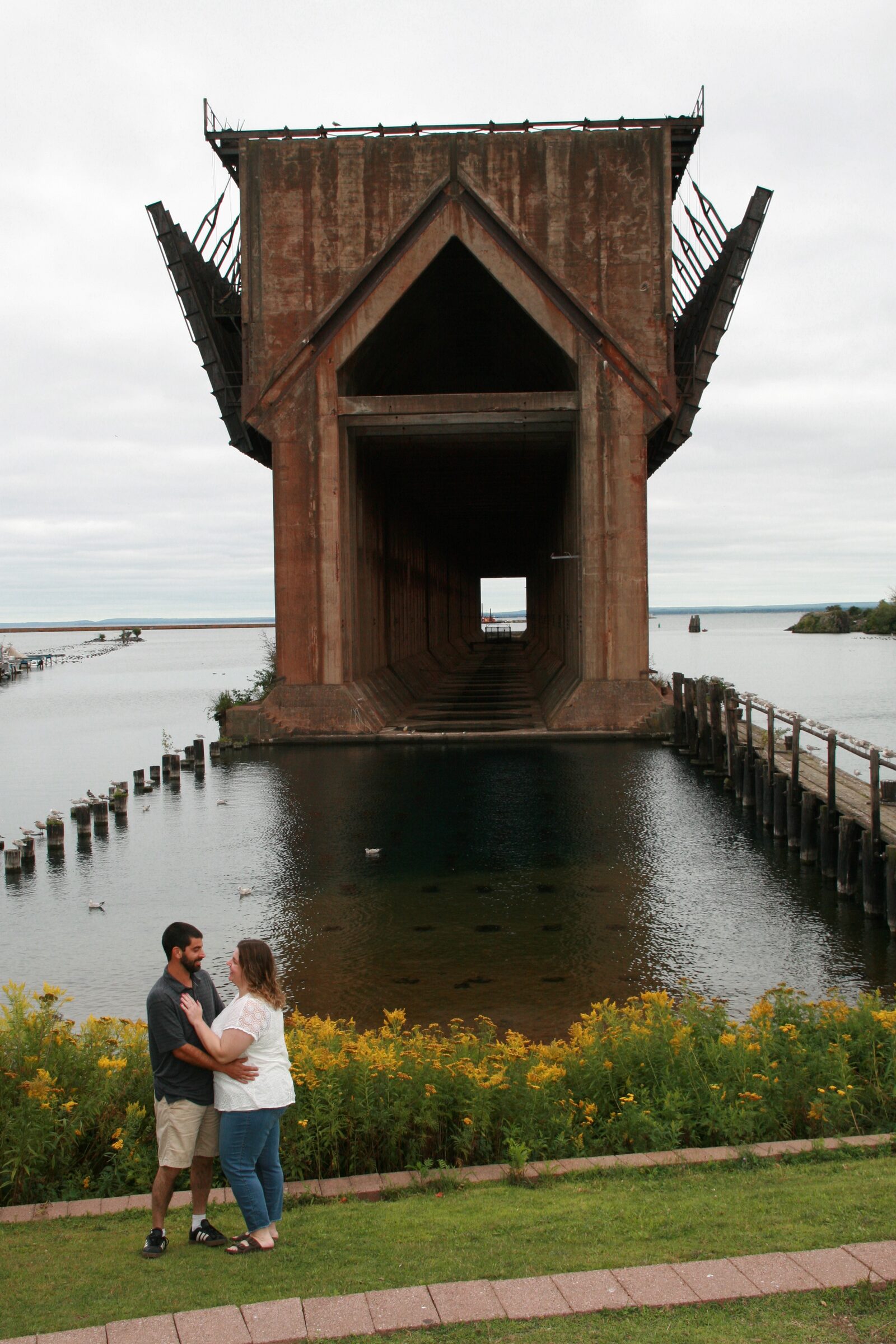 Tessa and Julian standing together by the waterfront